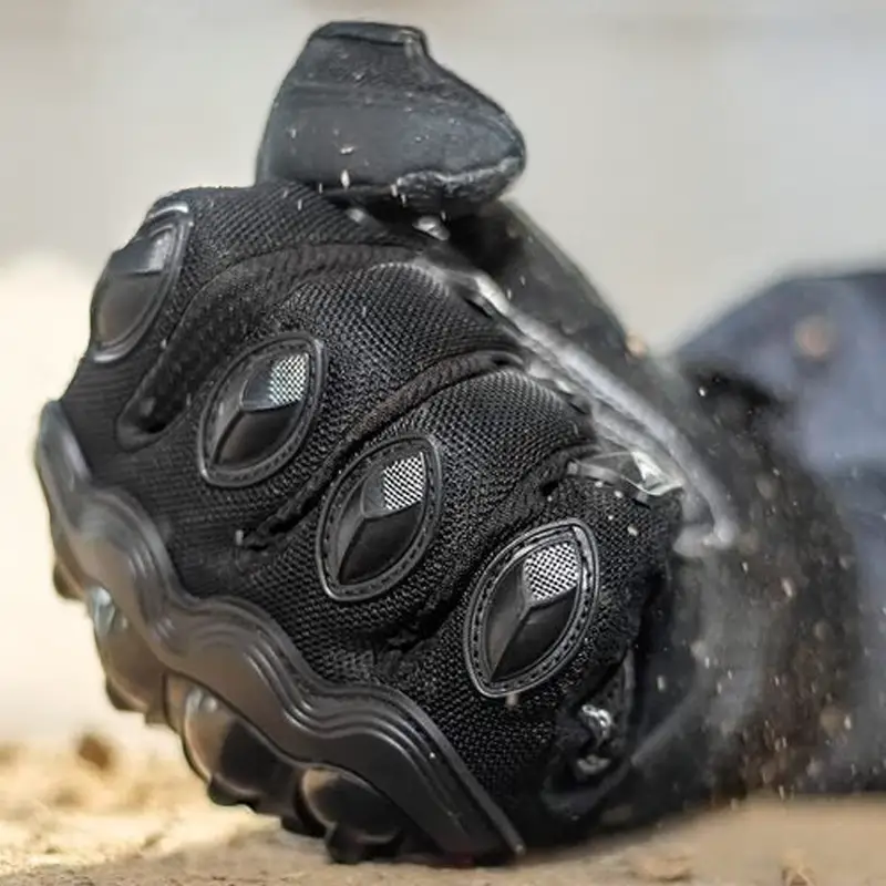 right-arm-fisted-hand-wearing-a-black-motorcycle-glove.webp