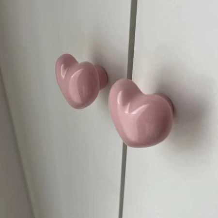 pink-heart-shaped-drawer-knobs-on-cupboards-angled-shot