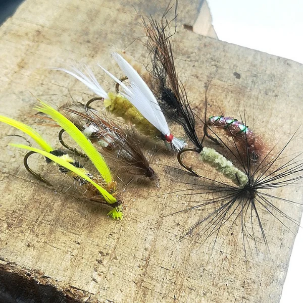 Yellow-white-and-black-fishing-flies.webp