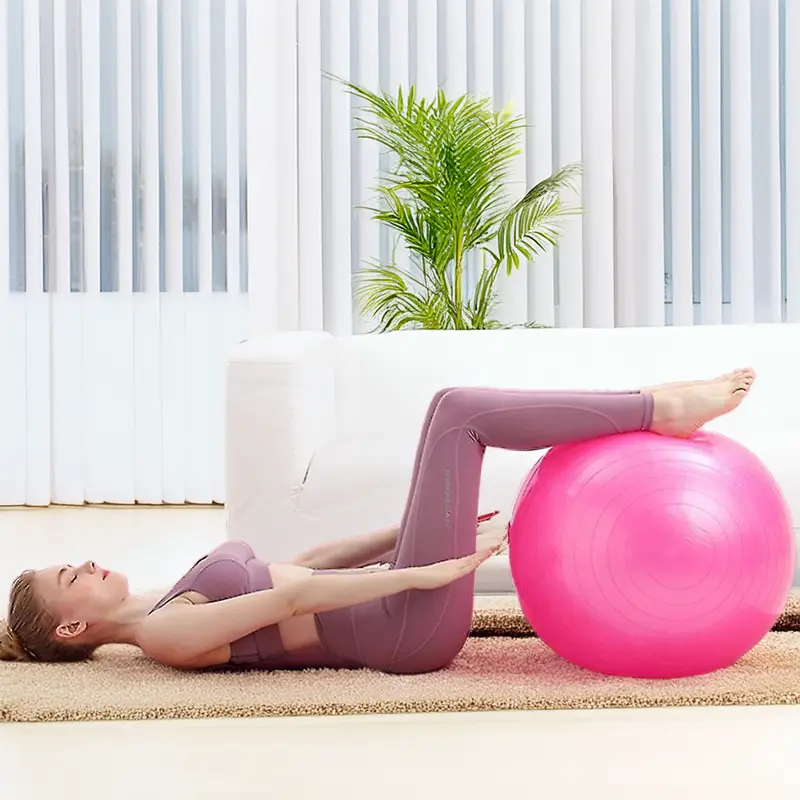 woman-using-a-pink-balance-ball-at-home.webp