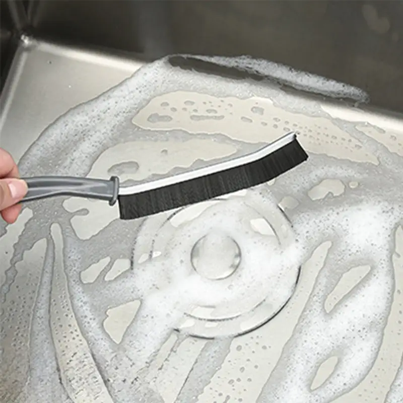 cleaning-around-the-plug-hole-with-a-narrow-cleaning-brush.webp