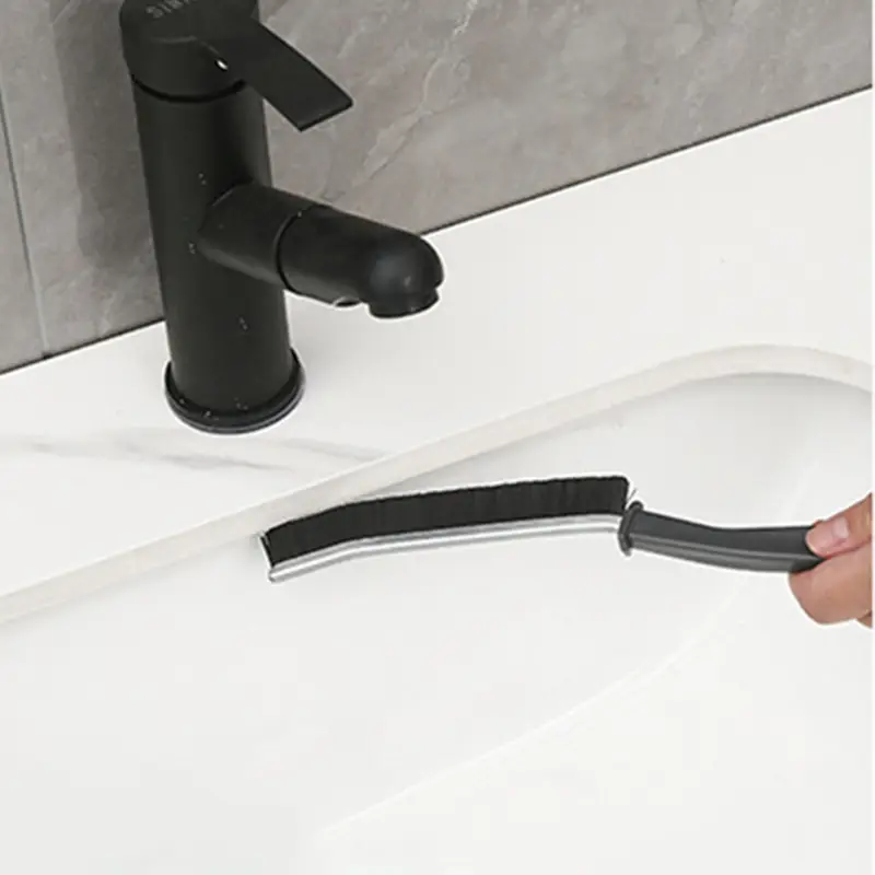 cleaning-between-sink-and-sink-top-with-a-crevice-cleaning-brush.webp