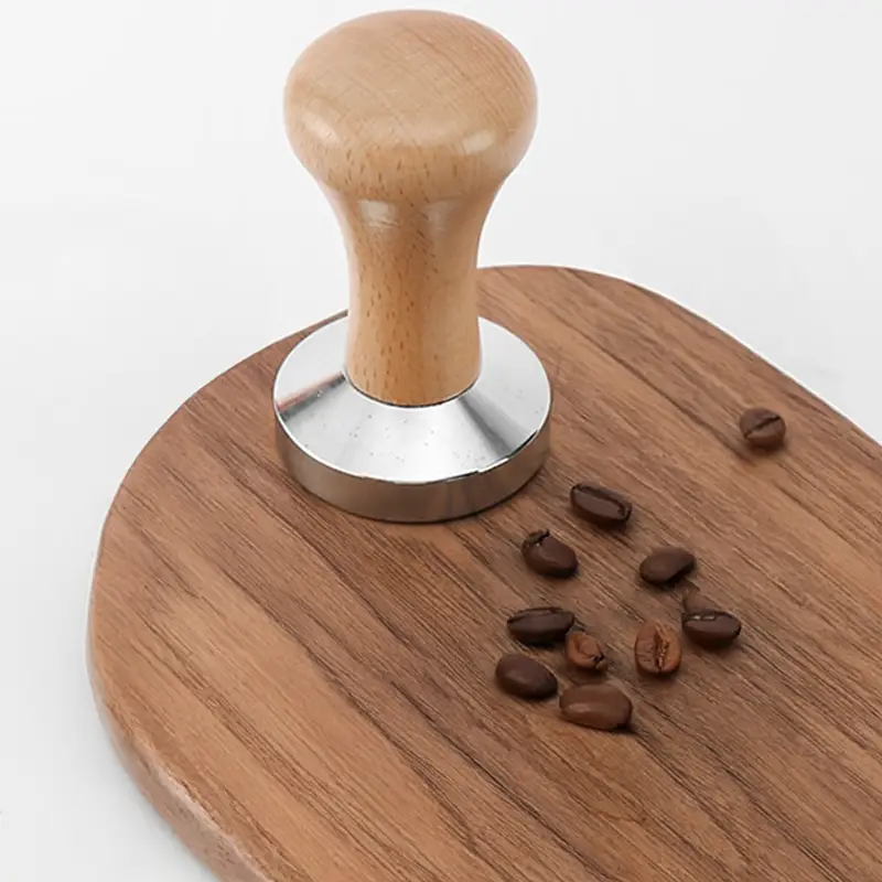 espresso-tamper-on-a-board-with-coffe-beans.webp