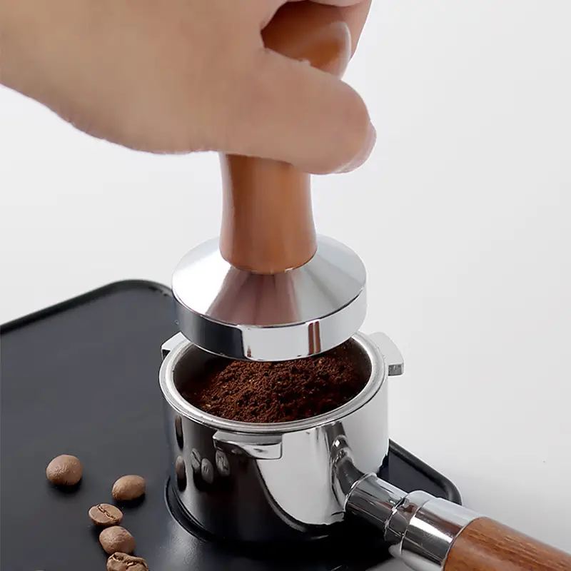 tamping-espresso-coffee-with-a-53mm-tamper.webp